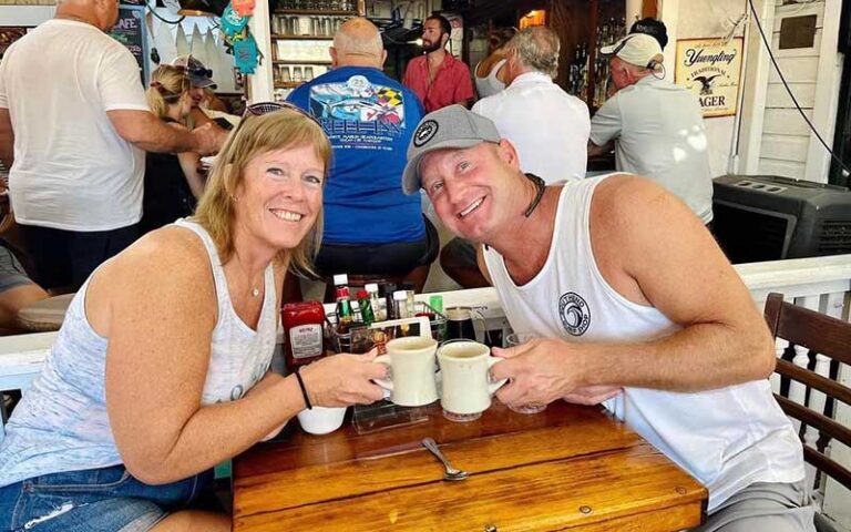 couple toasting coffees at outside bar area at pepes cafe key west