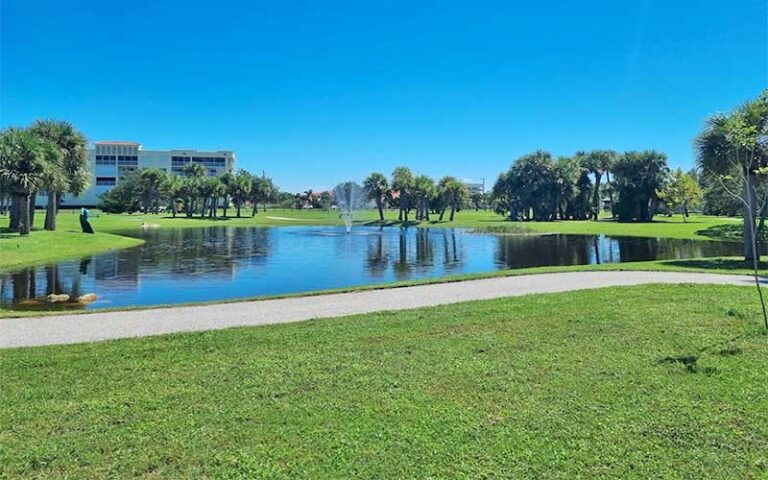 curvy pond with walkway and fountain at manatee sanctuary park cape canaveral