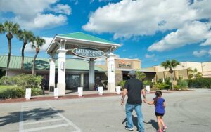 dad and kid walking toward mall entrance at melbourne square space coast