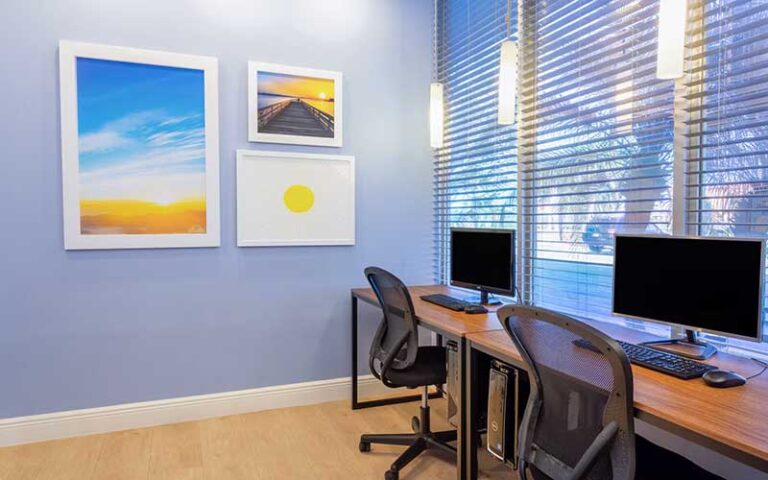 desks with computers in business center room at days inn by wyndham titusville kennedy space center