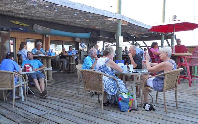 diners on dock patio with bar at the old fish house bar grill grant valkaria