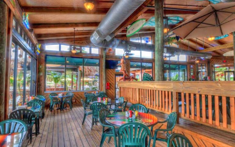 dining area of restaurant with rustic wood decor at grills riverside seafood deck tiki bar melbourne