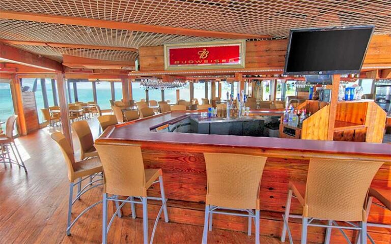 dining room and bar with ocean view windows at pier 62 oceanfront restaurant bar cocoa beach