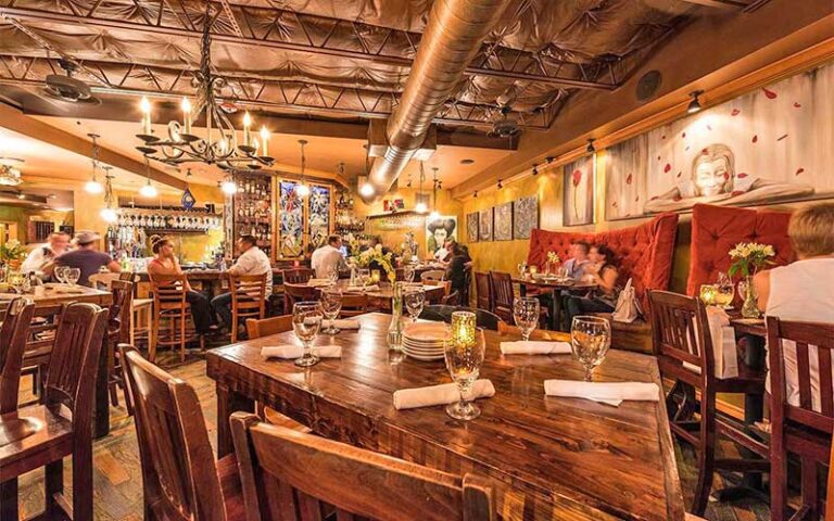 dining room interior with wood tables and bar at santiagos bodega key west