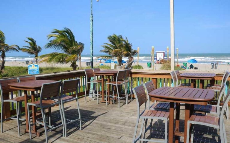 dining tables on patio overlooking beach at coconuts on the beach cocoa