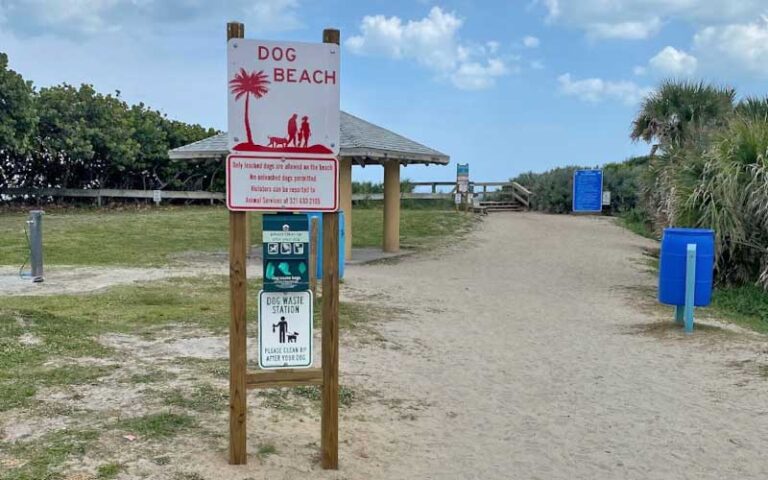 dog beach sign on path to dunes and pavilion at canova beach park indialantic