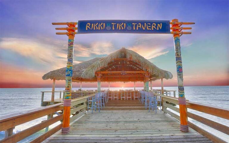 end of pier bar with gateway and sunrise over ocean at westgate cocoa beach pier