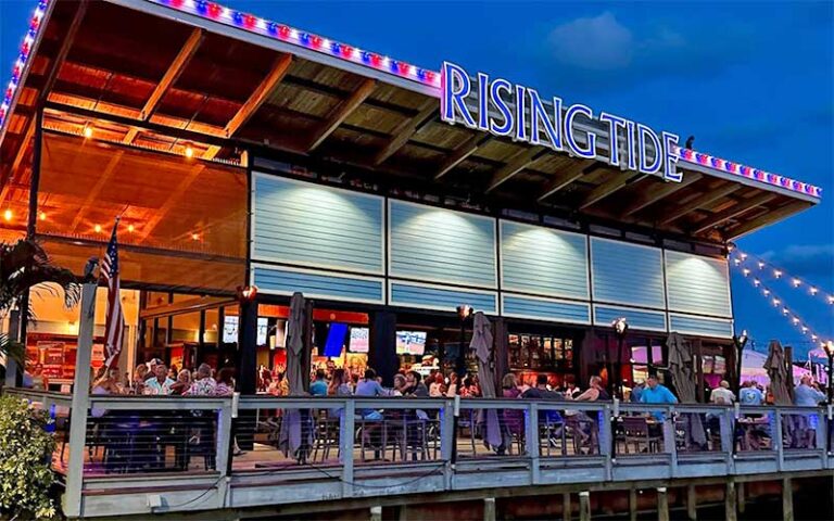 evening view of balcony with diners at rising tide tap table port canaveral