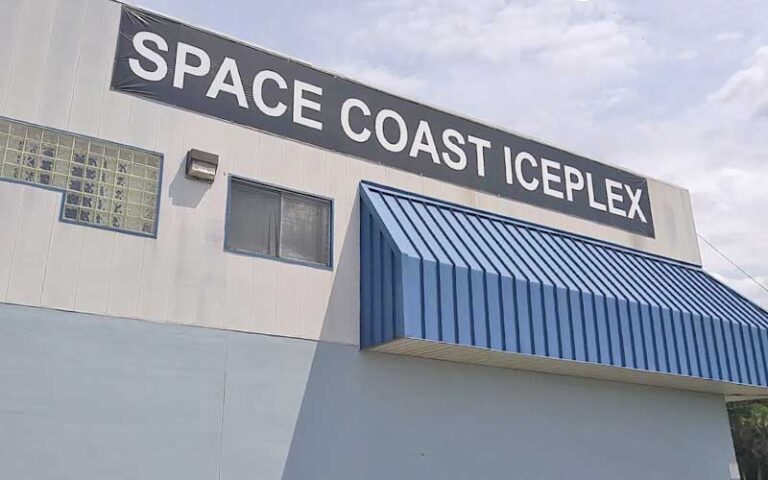 exterior of large building with awning and sign at space coast iceplex rockledge