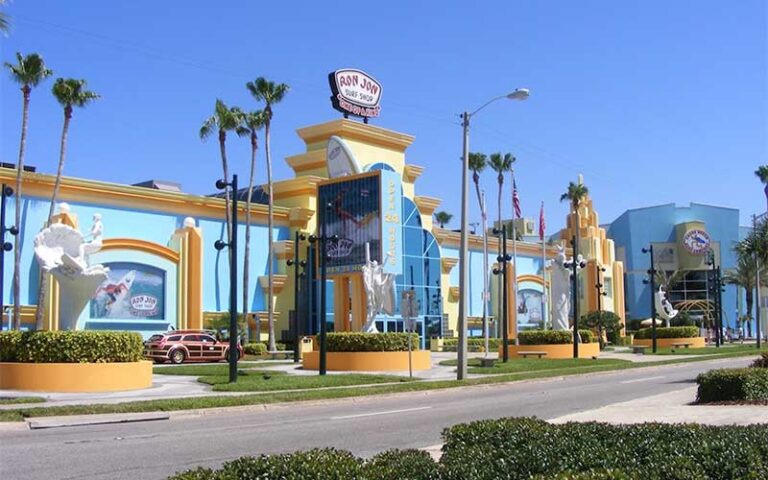 exterior street view of large ron jon surf store with palm trees at cocoa beach space coast