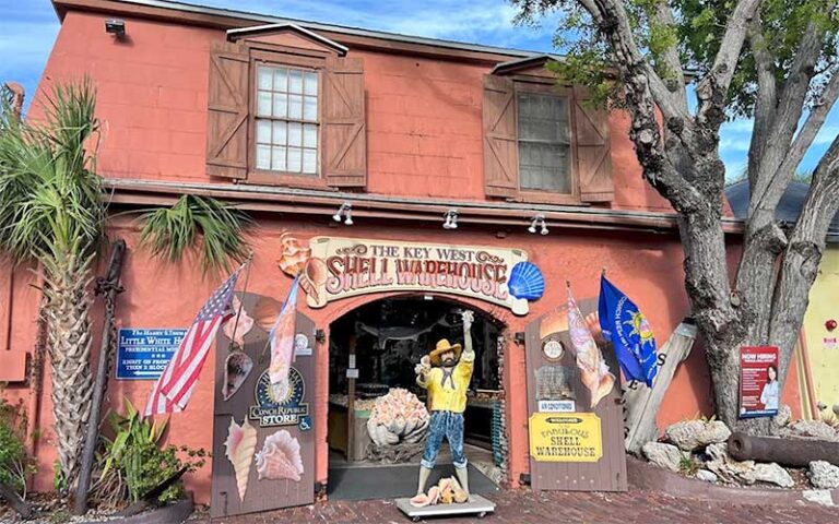 front exterior of barn like store with pirate at the key west shell warehouse