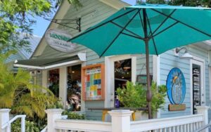 front exterior of cottage diner with sign and patio umbrella at moondog cafe key west