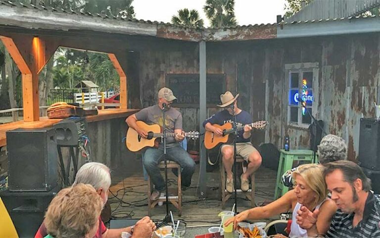 guitarists playing live music on patio dining at the old fish house bar grill grant valkaria