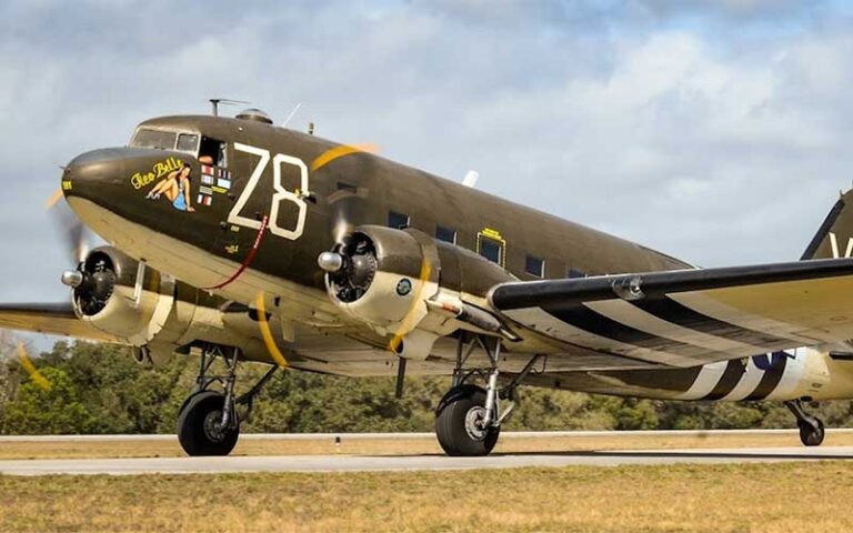 large bomber style airplane with props spinning on runway at valiant air command warbird museum space coast