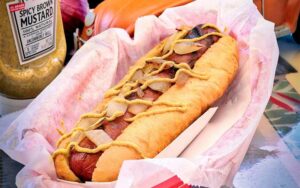 large hot dog with onion and mustard at long doggers cocoa beach