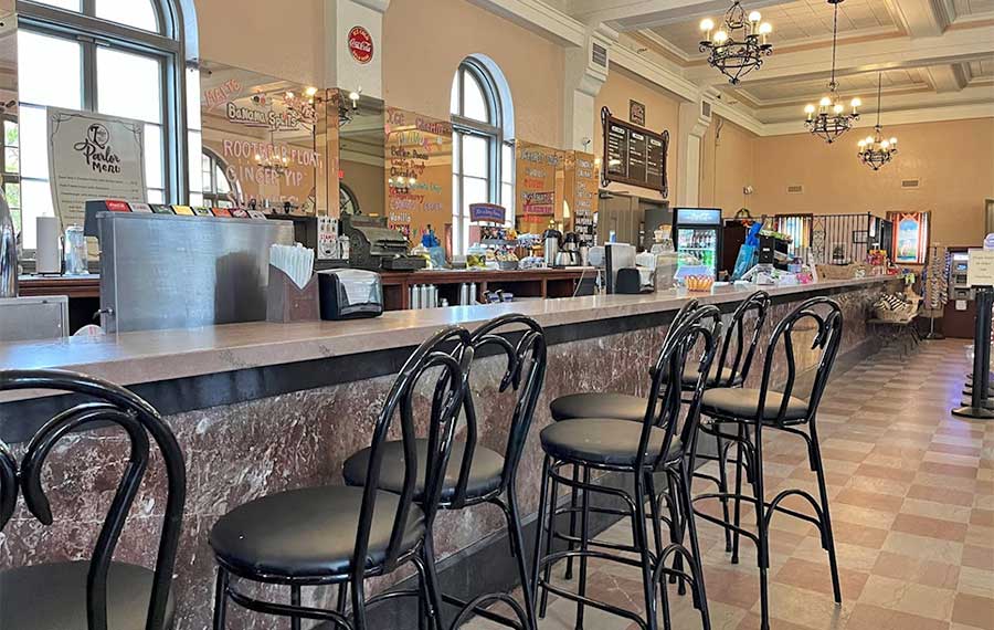 long marble bar with chairs and taps at soda shop restaurant at wakulla springs lodge