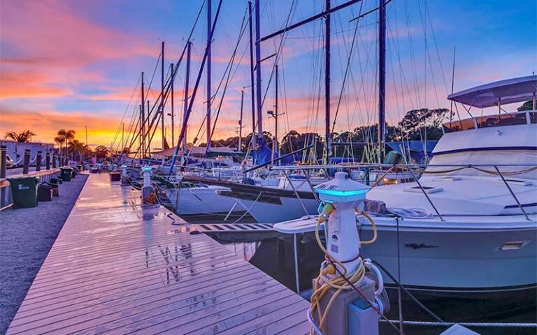 marina with boats at sunset at dolphins waterfront bar grill at cape crossing merritt island