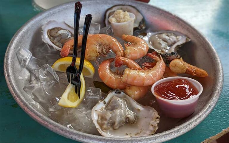 metal plate with shrimp and oysters on ice at schooners wharf bar key west