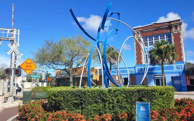 metal sculpture in median area with railroad signs at downtown melbourne space coast