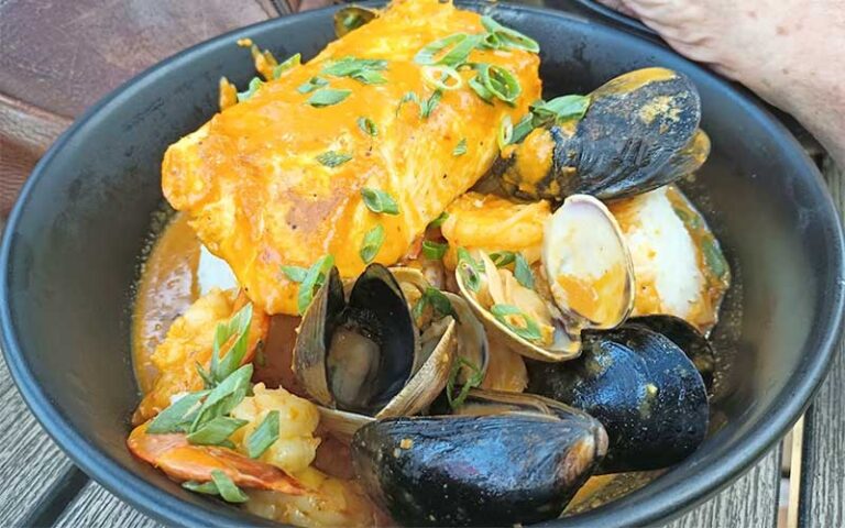 mussels and crab entree in black bowl at dolphins waterfront bar grill at cape crossing merritt island