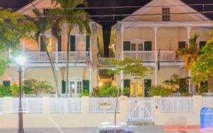 night exterior of hotel and fence from street at the duval house key west