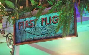 night lighted exterior sign at first flight island restaurant brewery key west