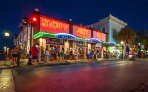 night view across street at restaurant exterior with neon signs at sloppy joes bar key west