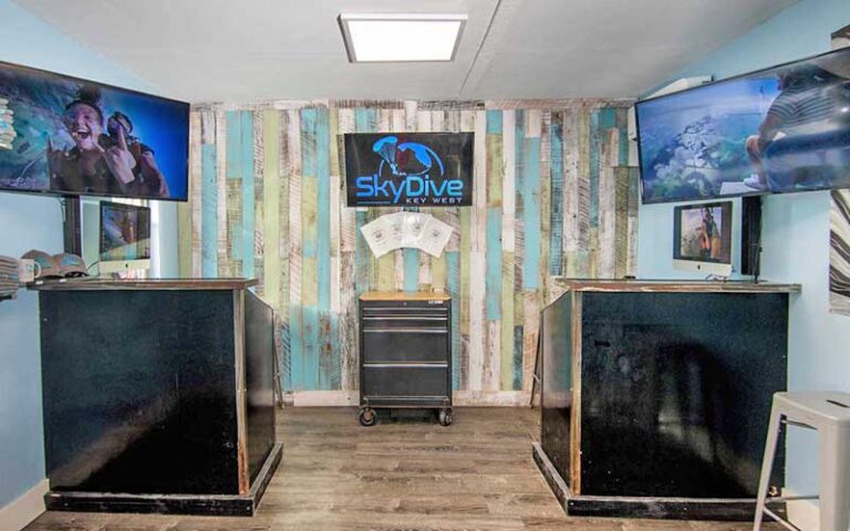 office with logo signs and screen at skydive key west