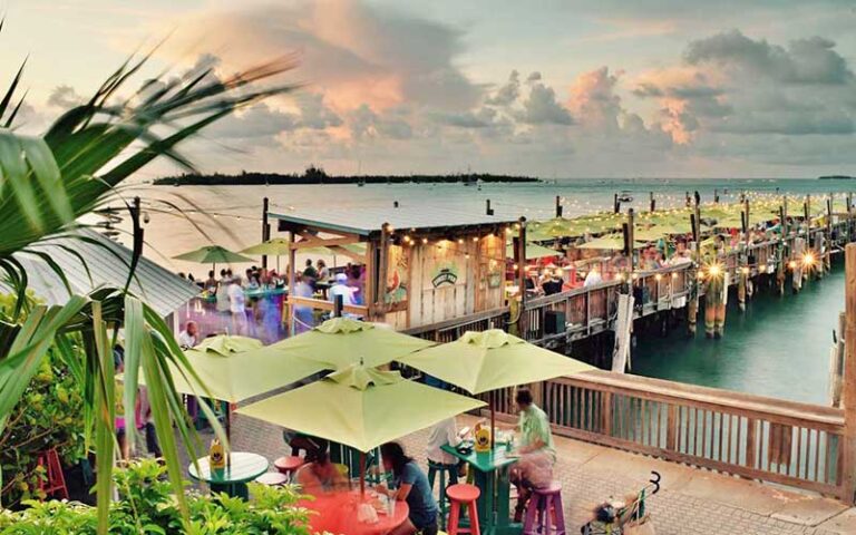 outdoor dining area along dock with sunset sky at sunset pier key west