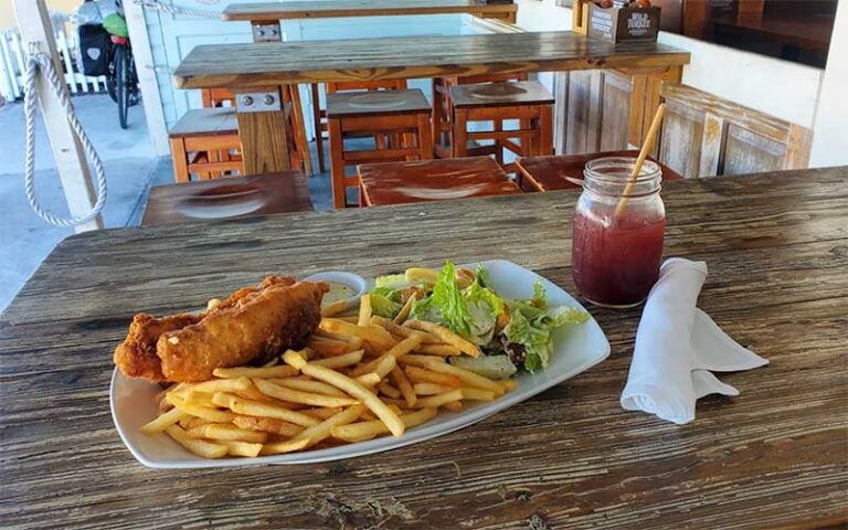 outdoor dining table with fried seafood entree at harpoon harrys key west