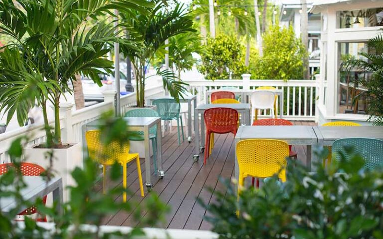 outside patio deck with colorful chairs at moondog cafe key west