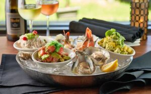 oysters on ice platter with sides at river rocks rockledge