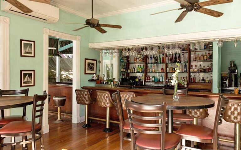 parlor with bar and leather seating at bagatelle key west