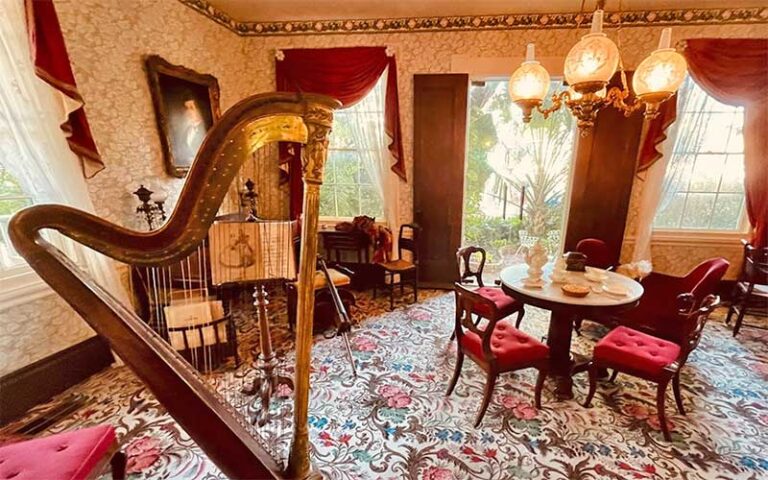 parlour room with harp and seating at audubon house tropical gardens key west