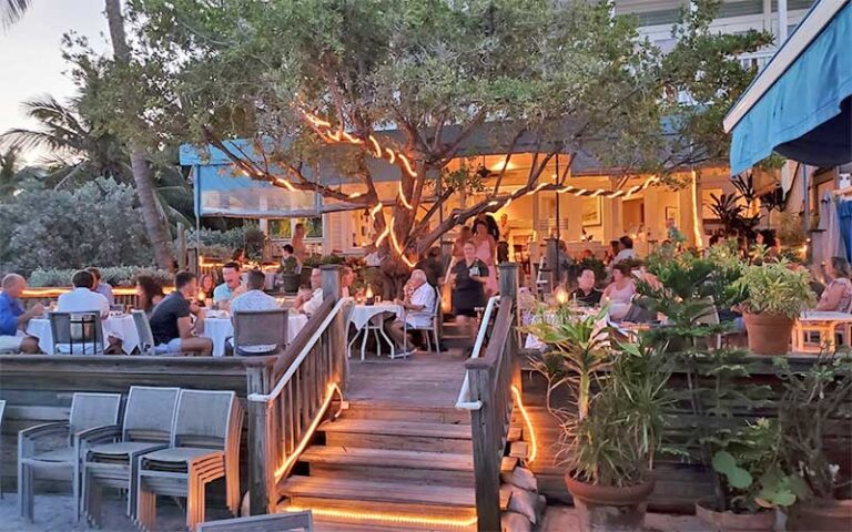 patio deck dining area with string lighted tree at louies backyard key west