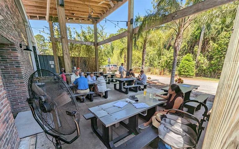 patio dining area with brick and open timber at playalinda brewing company titusville