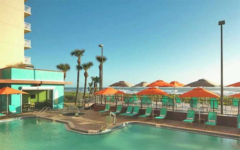 pool area with loungers at doubletree suites melbourne beach oceanfront