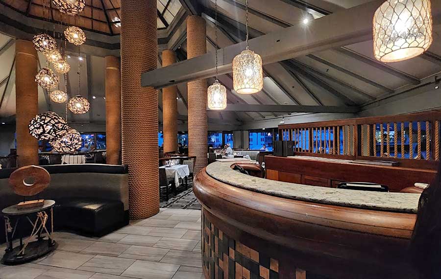 restaurant interior with globe pendant lights and open timbers at chart house daytona beach