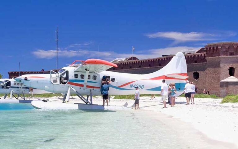 seaplanes parked on beach with fort at key west seaplane adventures