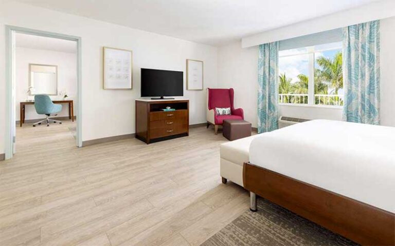 spacious suite with bed and view at hilton garden inn key west