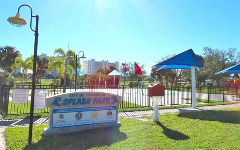 splash pad with fence and sign at sand point park titusville