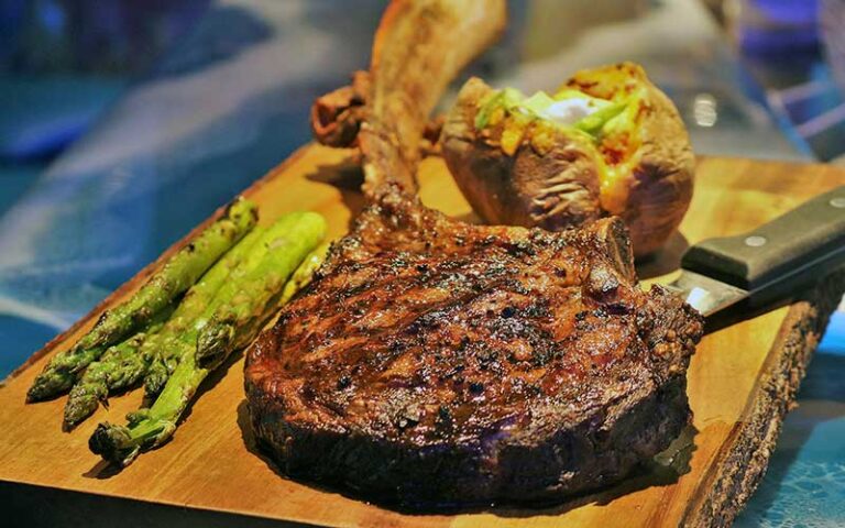 steak and baked potato on carving board at coconuts on the beach cocoa