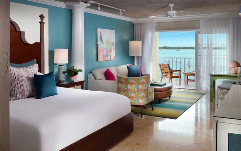 suite with king bed and balcony view at ocean key resort spa key west