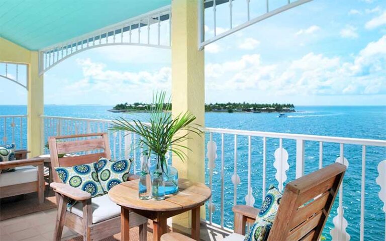 tables and chairs with balcony view of sunset key at ocean key resort spa key west