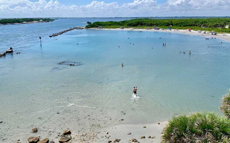 tidal pool with swimmers and inlet opening at sebastian inlet state park melbourne beach