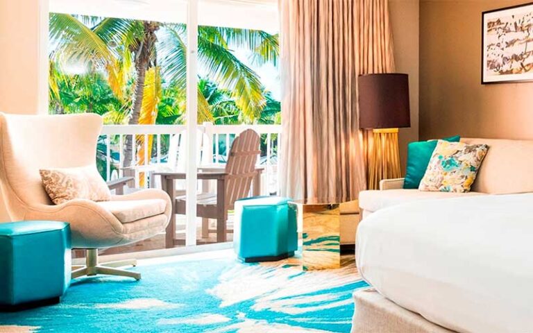 tropical decor guestroom with balcony at doubletree by hilton grand resort key west