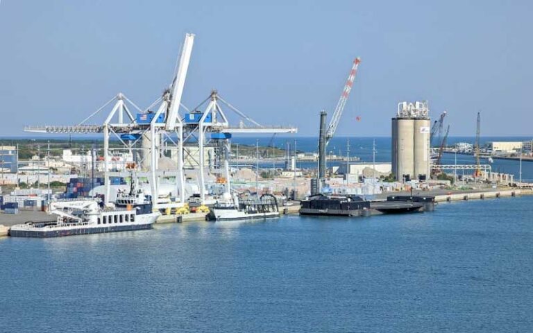 view from water of cargo cranes and silos at port canaveral space coast