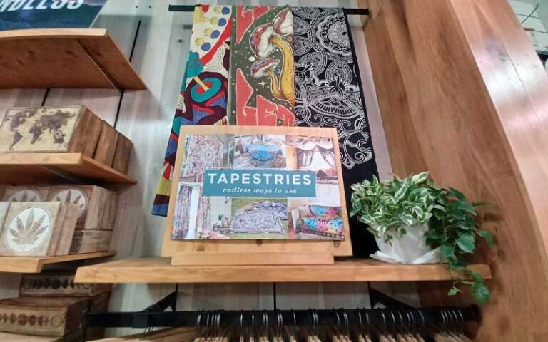 wood shelves with tapestries on rack at earthbound trading co key west