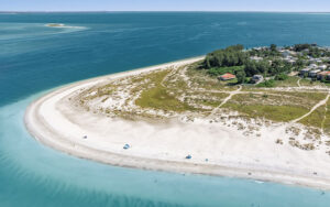 aerial view of tip of island with white sand cape and sandbar at bean point beach anna maria island