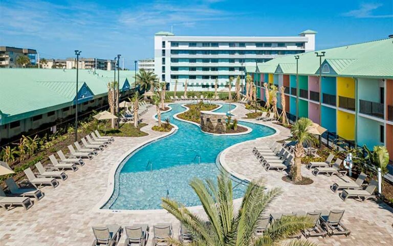 balcony view of resort courtyard with pool and loungers at beachside hotel suites cocoa beach